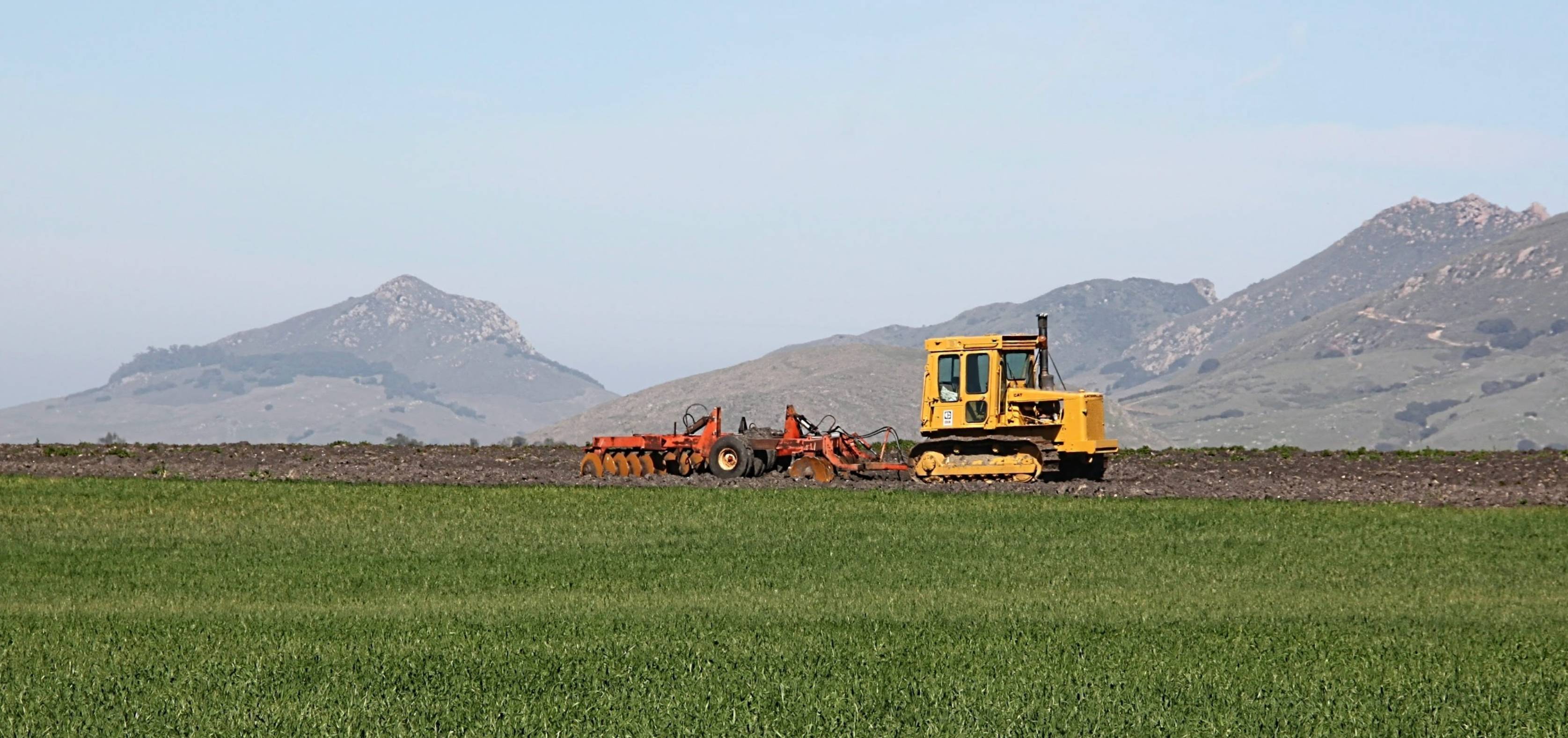 Agricultural equipment working in California Central Coast farmland